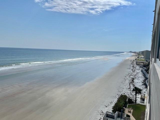 An elevated view of a sandy beach and ocean coastline from a building balcony — 4453 S ATLANTIC AVENUE UNIT 604, PONCE INLET, FL
