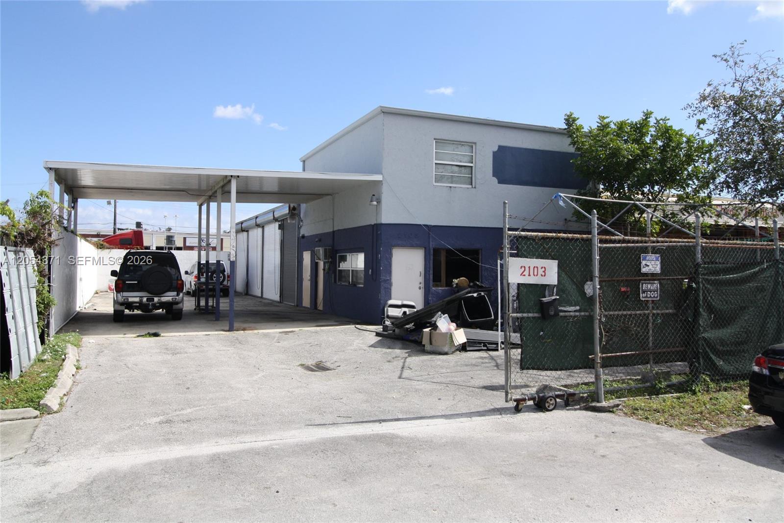 A two-story industrial building features a covered parking area and a fenced-in lot — 2103 SW 59th Ter, West Park FL 33023, WEST PARK, FL