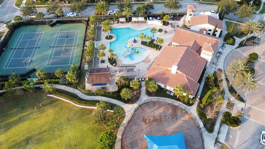 An aerial view shows a community recreation area with tennis courts, a pool, and clubhouse — 9306 MIRA VALLE LANE, WINTER GARDEN, FL