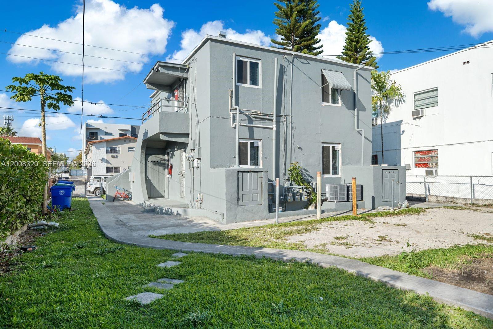 A two-story gray stucco building with an exterior staircase and multiple utility meters — 842 SW 3rd St, Miami FL 33130, MIAMI, FL