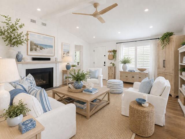 A bright living room features a fireplace, white furniture, blue accents, and a ceiling fan — VERO BEACH, FL