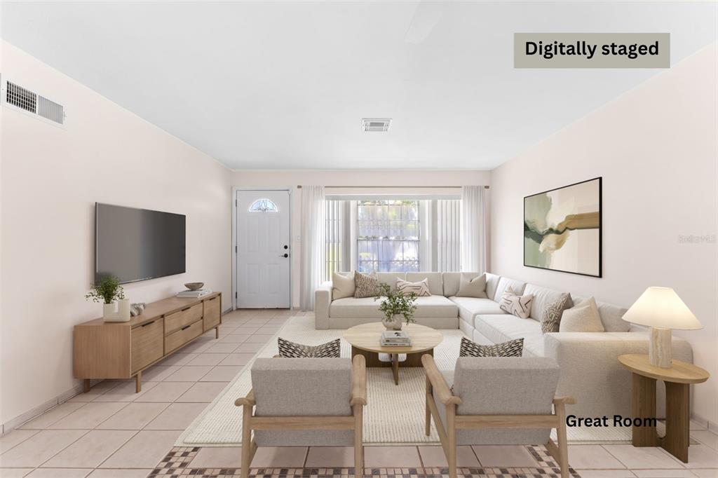 This digitally staged living room features a sectional sofa, two armchairs, and a television — 341 W DOVER STREET, SATELLITE BEACH, FL