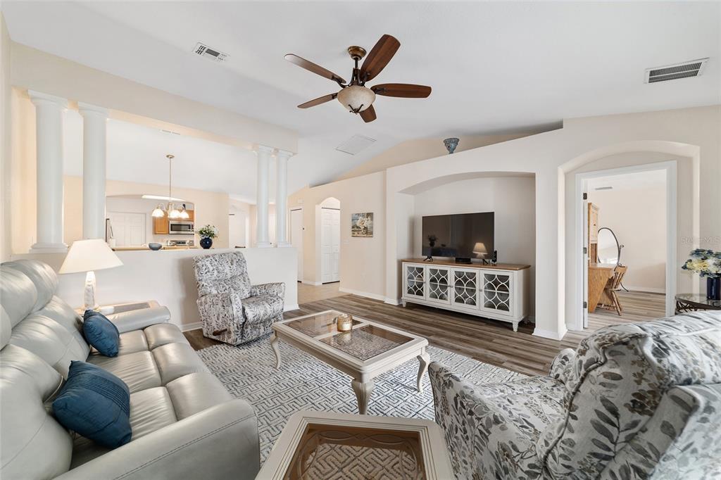 A living room features a vaulted ceiling, a ceiling fan, and a television on a console — 13640 SW 115TH AVENUE, DUNNELLON, FL