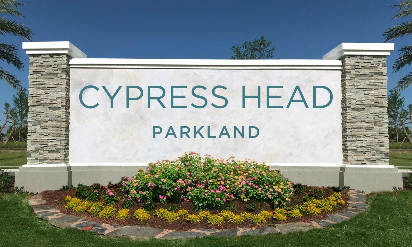 A stone and stucco monument sign for Cypress Head Parkland stands in a landscaped garden — 7511 Brigantine Lane, Parkland FL 33067, PARKLAND, FL