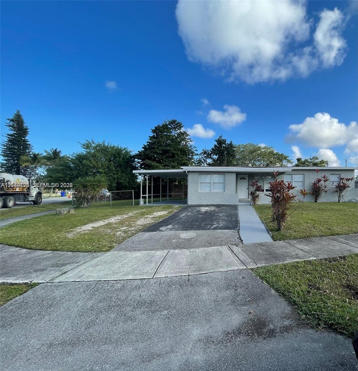 A single-story house with a carport, a paved driveway, and a front lawn — 4160 SW 36th St, West Park FL 33023, WEST PARK, FL
