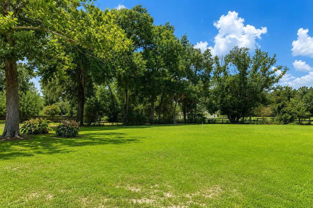 A spacious room with light blue walls, tile flooring, arched doorways, and a ceiling fan — 1452 DINGENS AVENUE, WINDERMERE, FL
