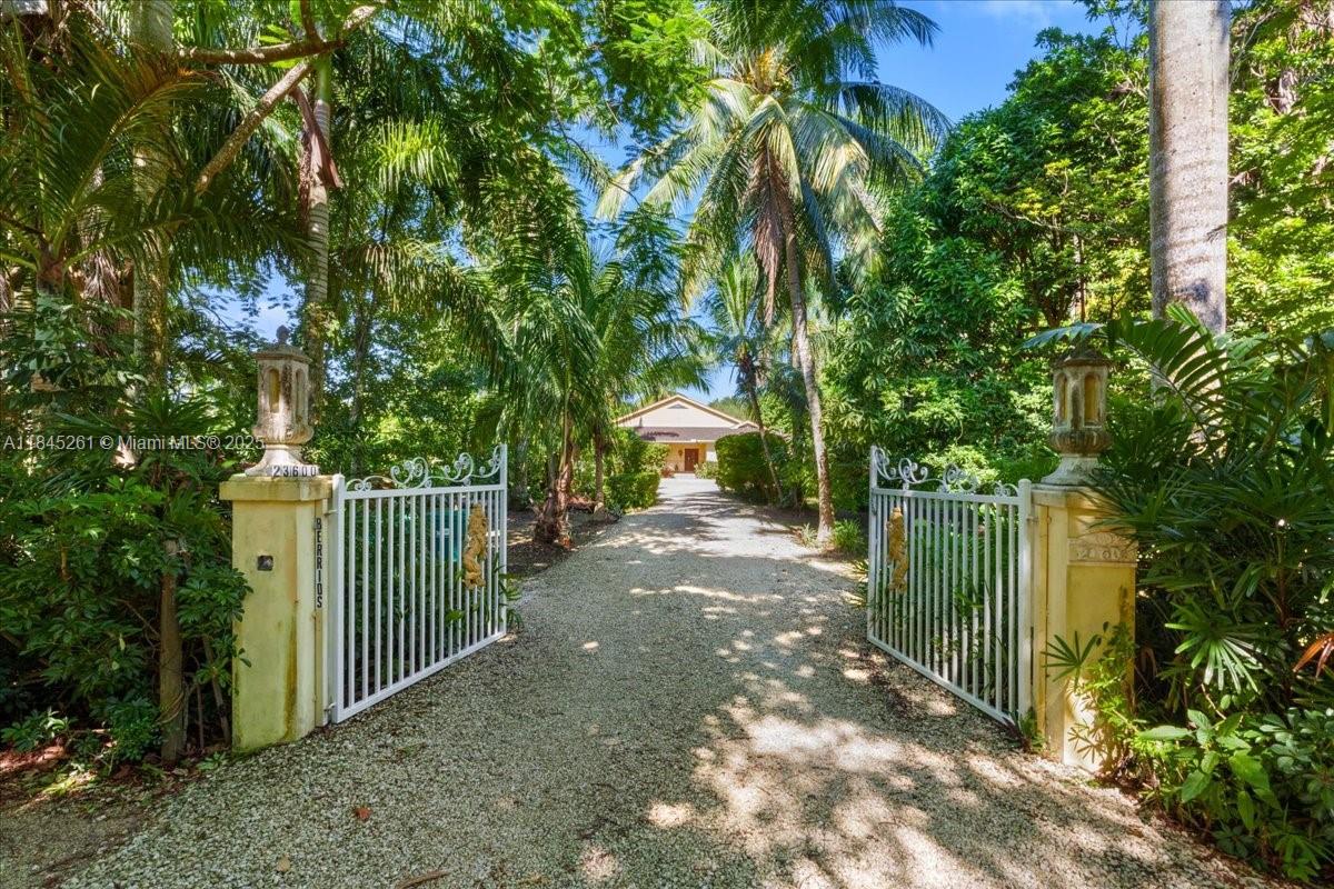 An aerial view shows a house with a swimming pool, hot tub, and lush landscaping — 23600 SW 187th Ave, Homestead FL 33031, HOMESTEAD, FL
