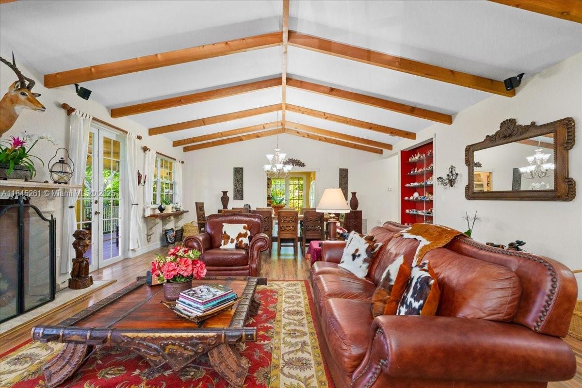 A dining room features a wooden table, carved chairs, exposed ceiling beams, and hardwood floors — 23600 SW 187th Ave, Homestead FL 33031, HOMESTEAD, FL