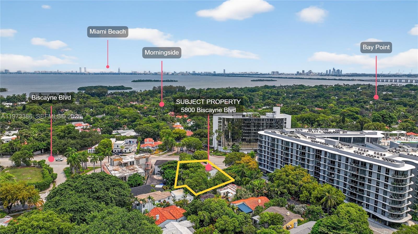 An aerial view shows a vacant, tree-covered lot surrounded by residential and commercial buildings — 5800 Biscayne Blvd, Miami FL 33137, MIAMI, FL
