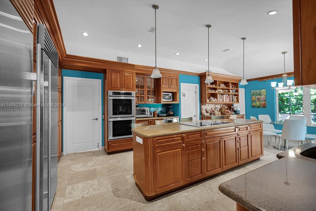 A kitchen with wood cabinets, a large island, and bright blue walls — 61 Camden Ct, Bal Harbour FL 33154, BAL HARBOUR, FL