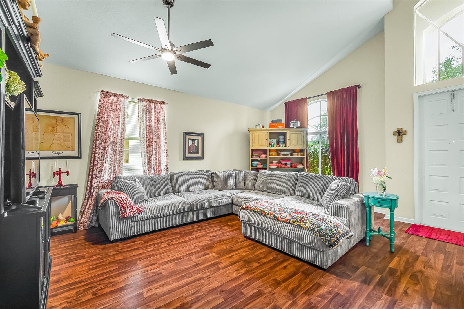 A living room features a grey sectional sofa, wood flooring, and a vaulted ceiling — 9262 Silver Glen Way, Lake Worth FL 33467, LAKE WORTH, FL