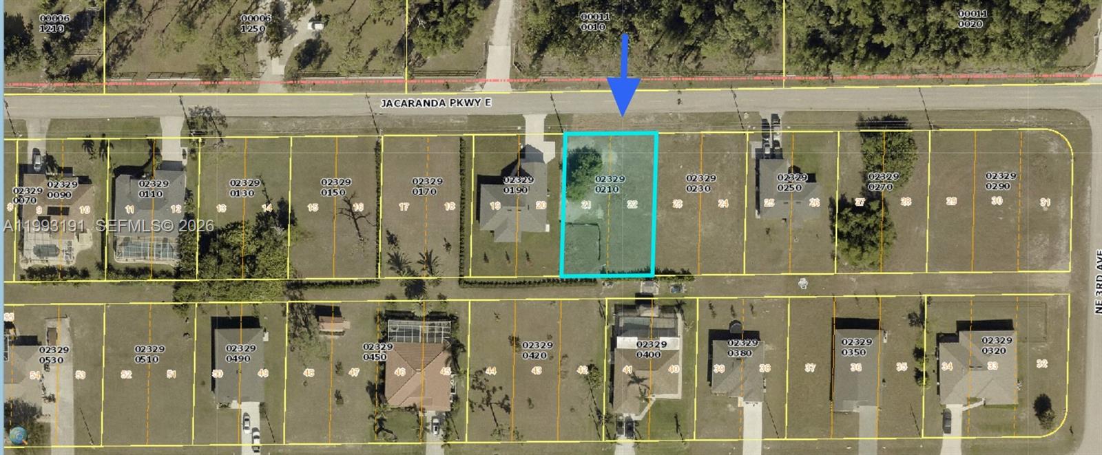 This is an aerial map showing a highlighted vacant residential lot along a paved road — 206 Jacaranda Pkwy E, Cape Coral FL 33909, CAPE CORAL, FL