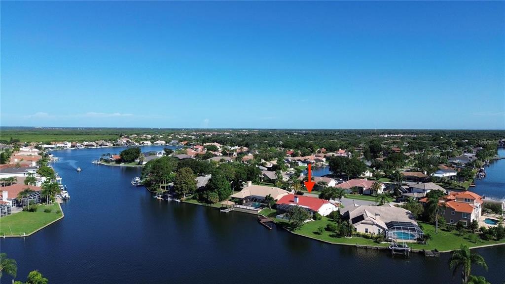 An aerial view shows a waterfront house with a red roof and a swimming pool — 4804 LONGWATER WAY, TAMPA, FL