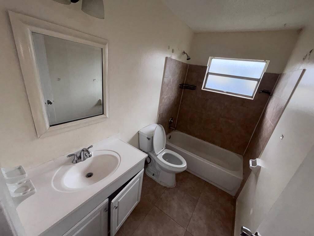 A bathroom featuring a white vanity, a toilet, and a tiled shower-tub combination — 2620 Riverland Drive # 2, Fort Lauderdale FL 33312, FORT LAUDERDALE, FL
