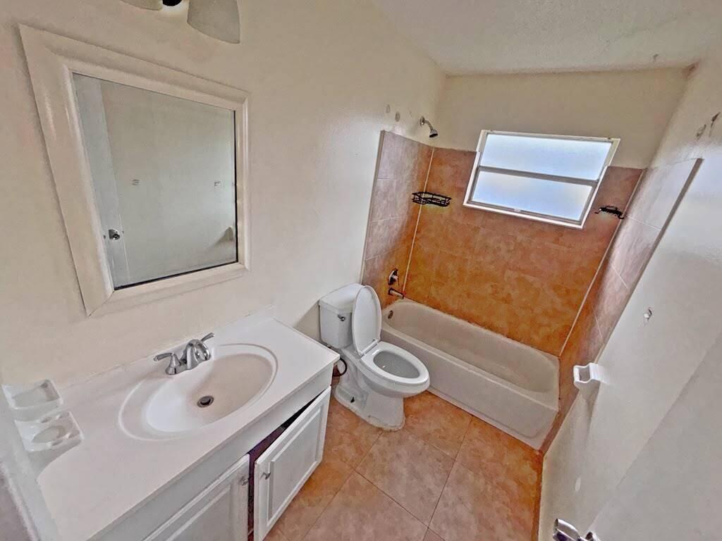 A bathroom features a vanity with a mirror, a toilet, and a tiled shower-tub combo — 2620 Riverland Drive # 2, Fort Lauderdale FL 33312, FORT LAUDERDALE, FL