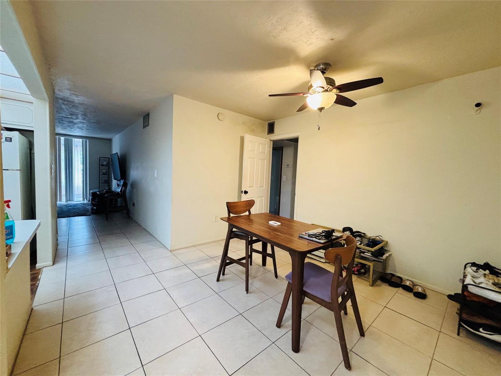 A dining area with tile flooring, a wooden table, and a ceiling fan — 7300 NW 17th Street # 202, Plantation FL 33313, PLANTATION, FL