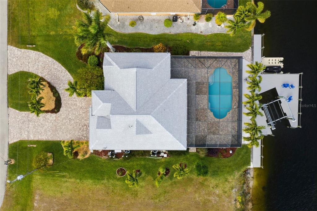 An aerial view of a waterfront house with a pool, screened lanai, and private dock — 2803 SW 34TH TERRACE, CAPE CORAL, FL