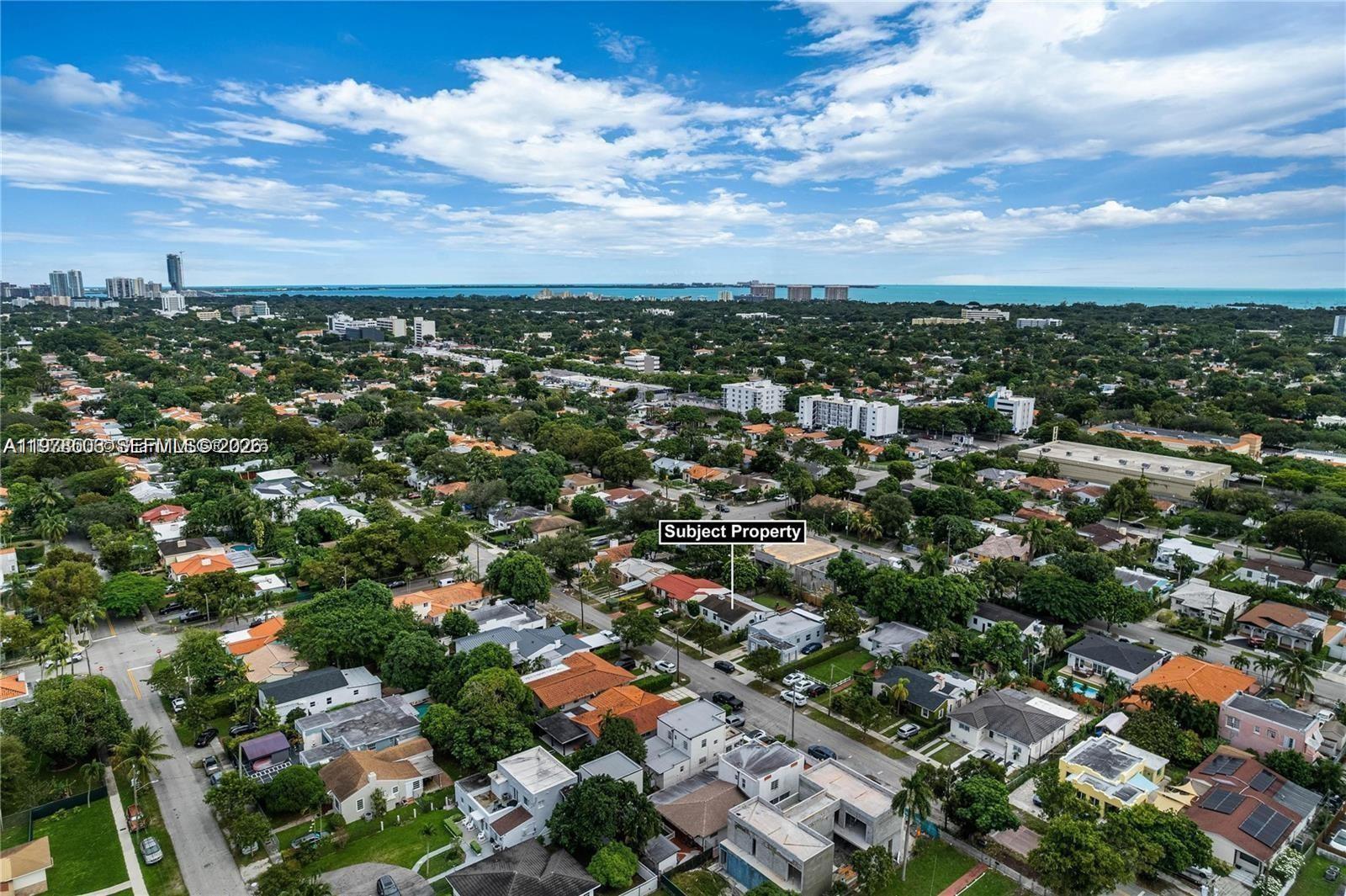 An aerial view shows a residential neighborhood with a marked house and distant ocean views — 2520 SW 20th St # 1, Miami FL 33145, MIAMI, FL