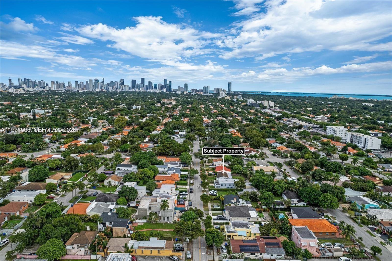 An aerial view shows a residential neighborhood with a marked property and a distant city skyline — 2520 SW 20th St # 1, Miami FL 33145, MIAMI, FL