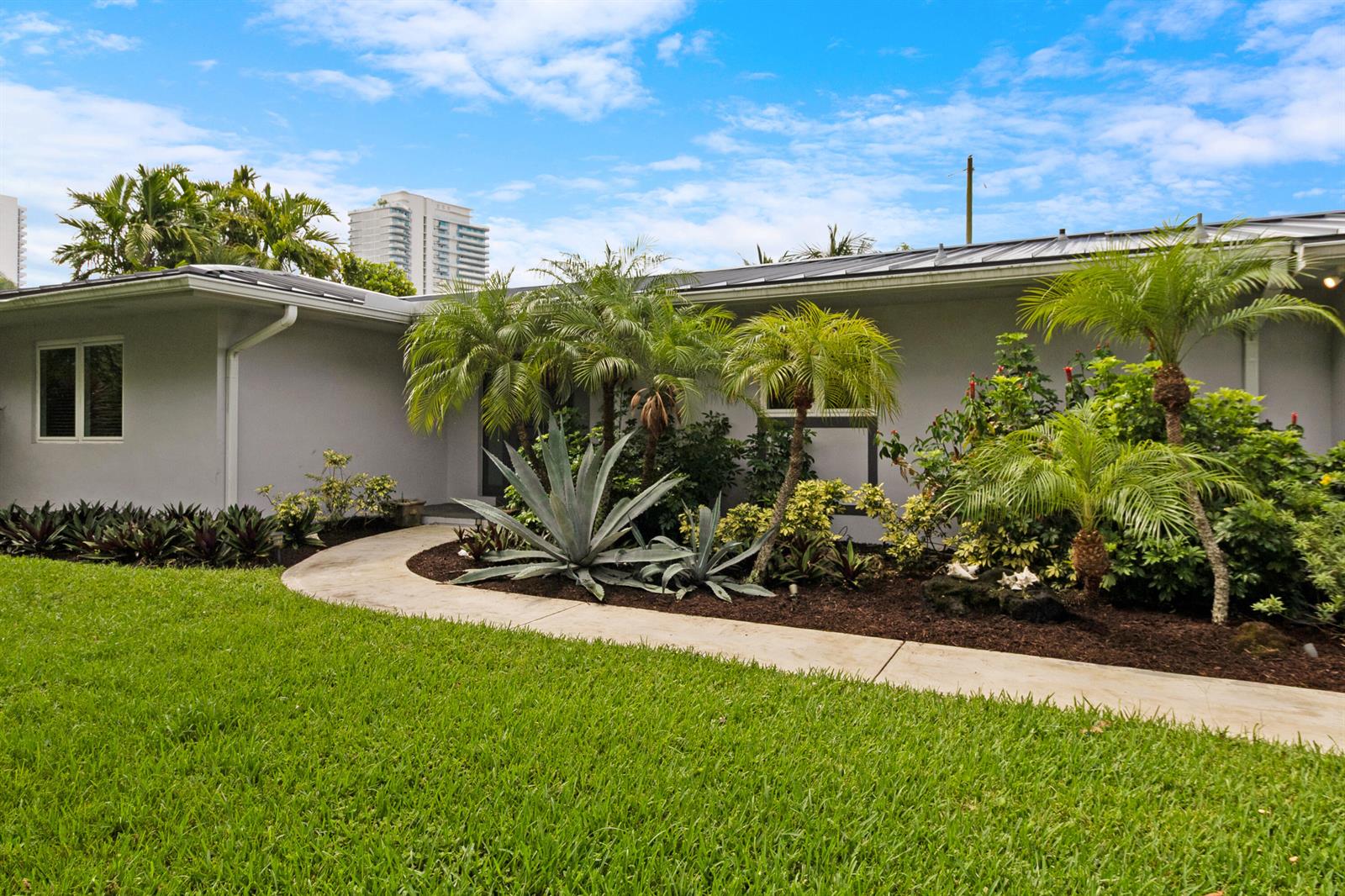 A single-story house with a curved concrete walkway, palm trees, and landscaping in the front yard — 3240 Lakeview Drive, Pompano Beach FL 33062, POMPANO BEACH, FL