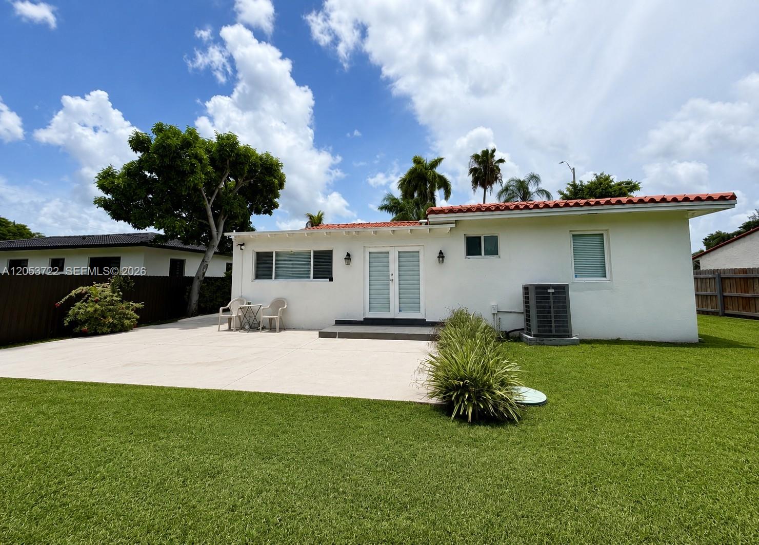 The exterior view shows a white house with a red tile roof and a patio — 6320 SW 24th St, Miami FL 33155, MIAMI, FL