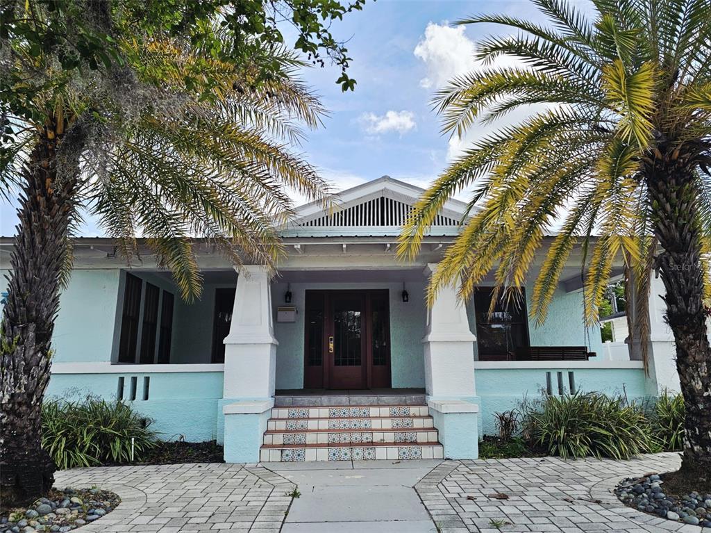 A waiting room with a fireplace, leather sofa, tiled floors, and a glass-paned exit door — 5409 N FLORIDA AVENUE, TAMPA, FL