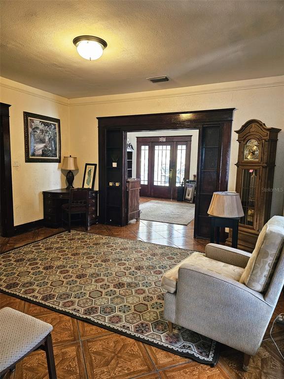 A home office features dark wood trim, a leather armchair, a desk, and built-in shelving — 5409 N FLORIDA AVENUE, TAMPA, FL