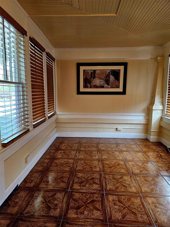 A home office features a dark wood desk, a television, and large windows with blinds — 5409 N FLORIDA AVENUE, TAMPA, FL