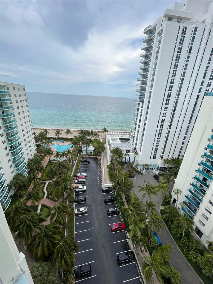 High-angle view of a parking lot between two tall residential buildings overlooking the ocean — 3901 S S Ocean dr, Hollywood FL 33019, HOLLYWOOD, FL
