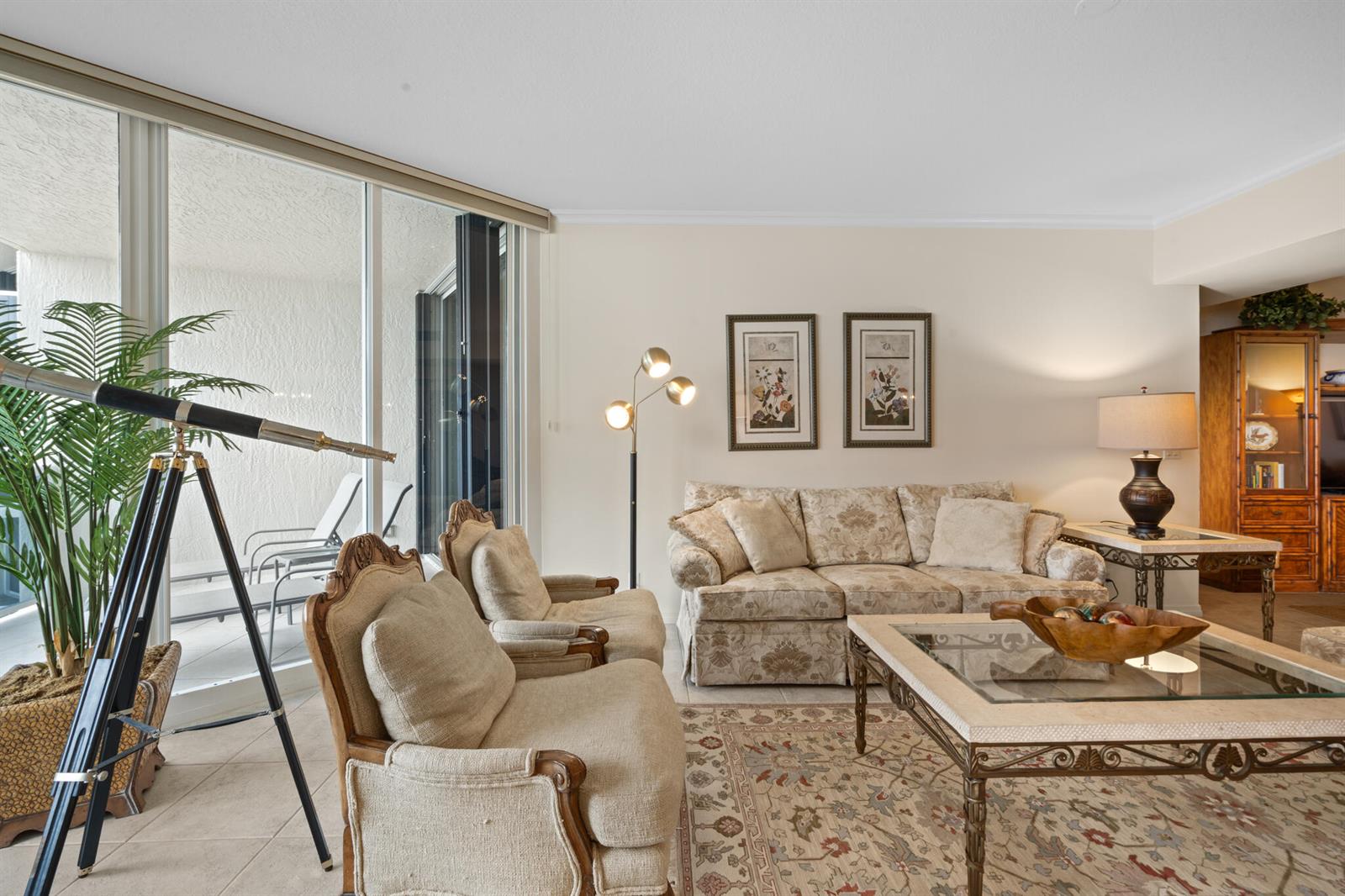 A living room features a patterned sofa, two armchairs, a glass-topped coffee table, and a telescope — 3200 N Ocean Boulevard # 1506, Fort Lauderdale FL 33308, FORT LAUDERDALE, FL