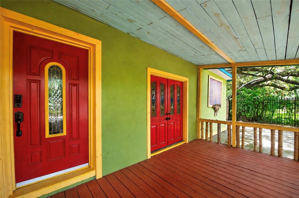 A covered porch with red doors, green walls, and a light blue wooden ceiling — 6270 62ND AVENUE N, PINELLAS PARK, FL