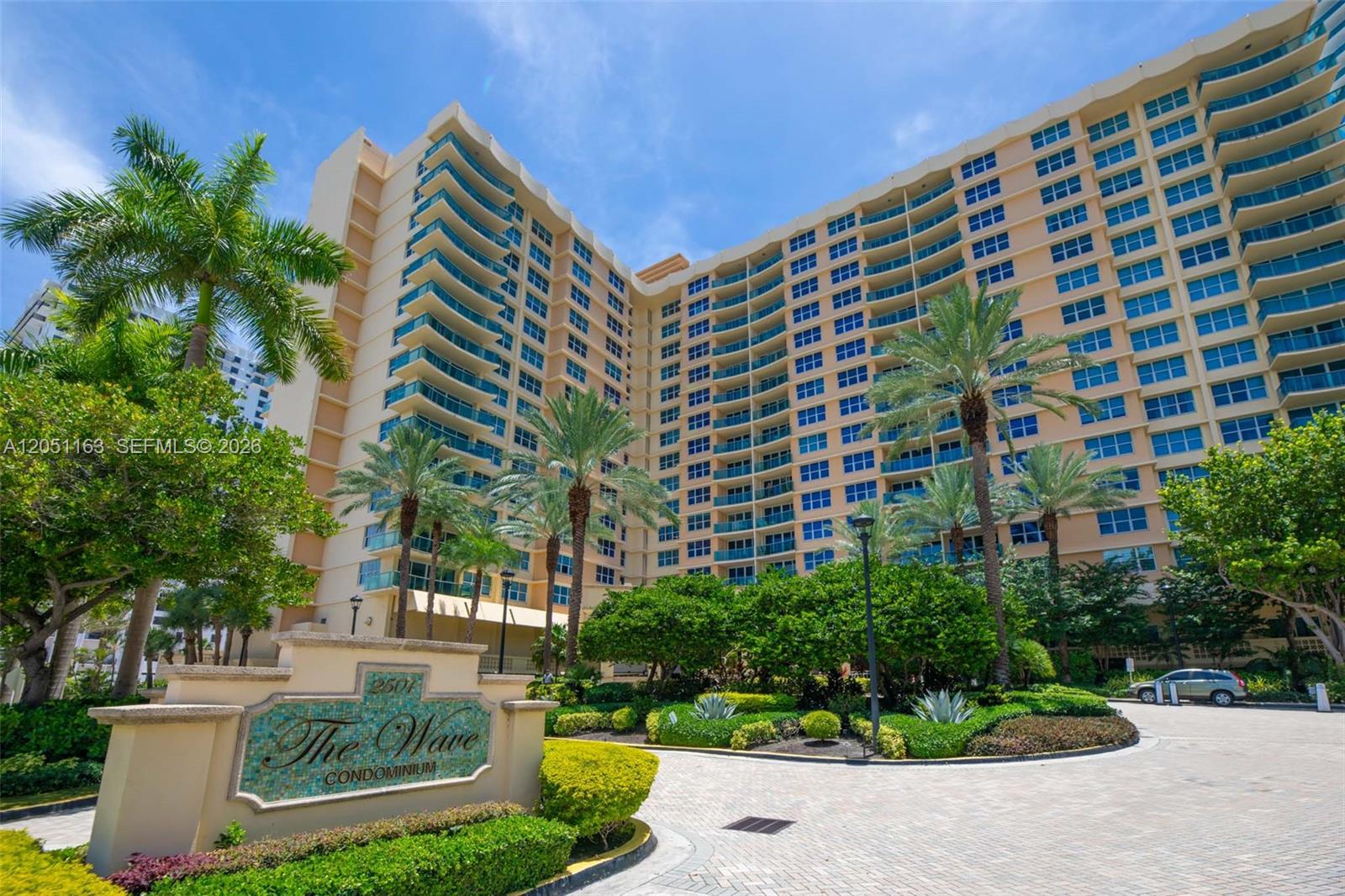 The exterior of a large, multi-story residential building with balconies and a landscaped entrance — 2501 S Ocean Dr # 828, Hollywood FL 33019, HOLLYWOOD, FL
