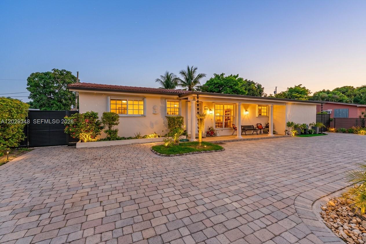 A single-story house with a paved driveway and a covered front porch at dusk — 884 W 72nd Pl, Hialeah FL 33014, HIALEAH, FL