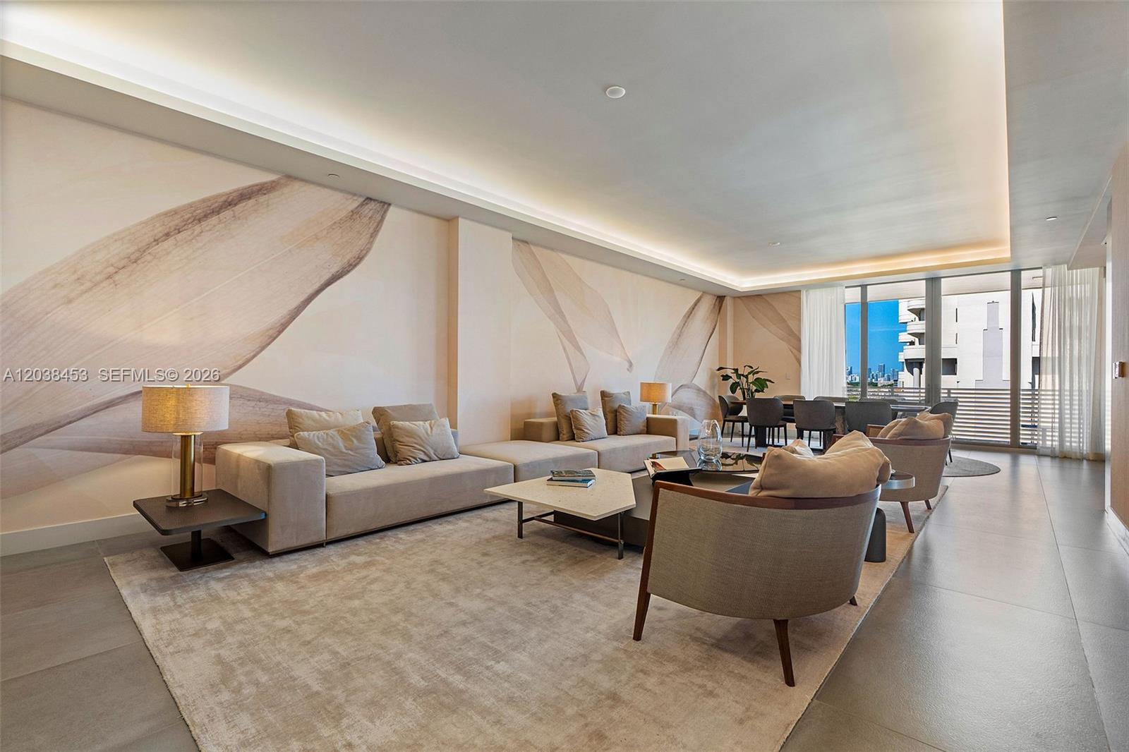 A modern living room features a large sectional sofa, patterned wall mural, and floor-to-ceiling windows — 515 Valencia Ave # 802, Coral Gables FL 33134, CORAL GABLES, FL
