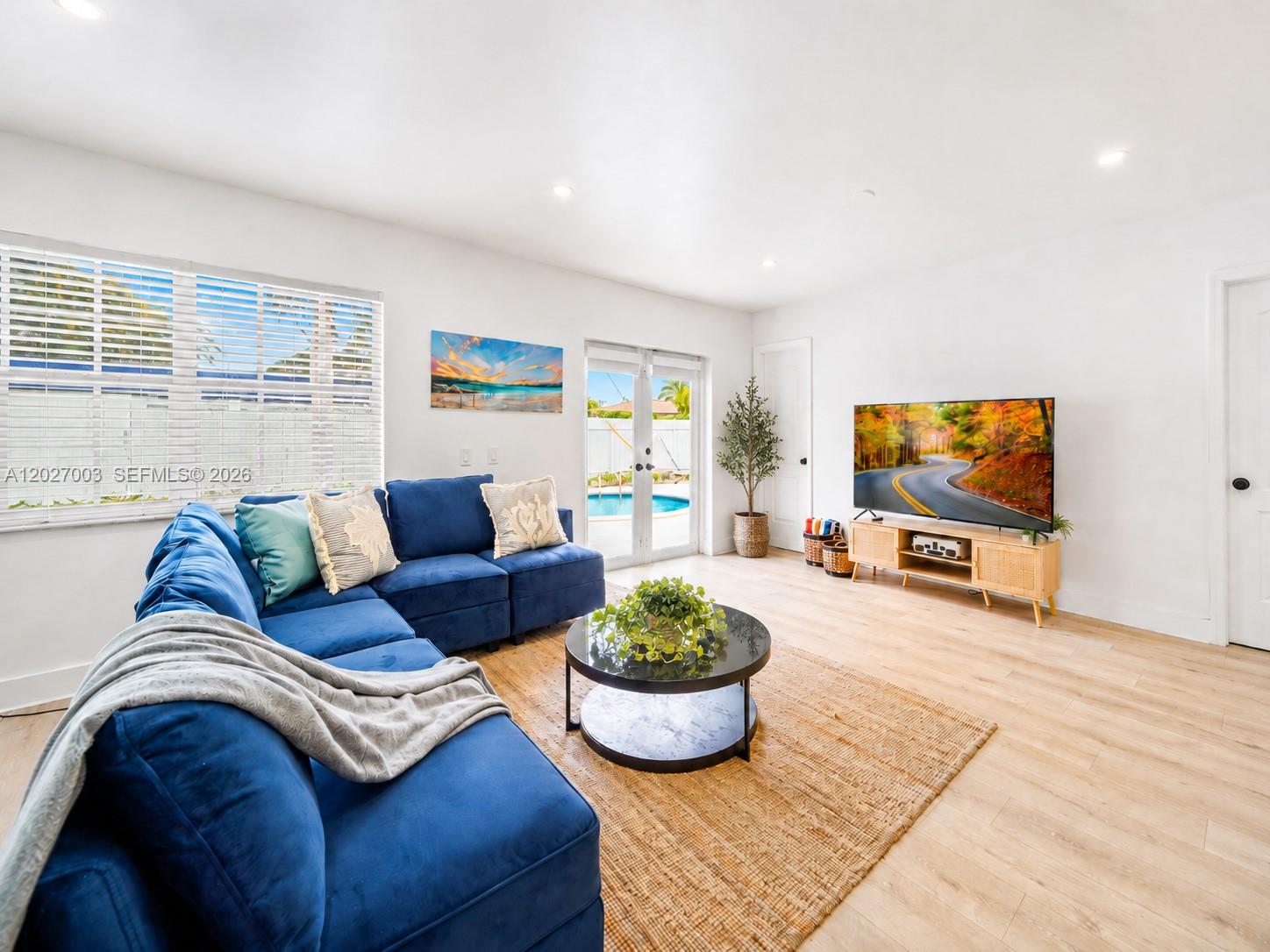 A living room features a blue sectional sofa, a round coffee table, and a television — 2761 SW 92nd Pl, Miami FL 33165, MIAMI, FL