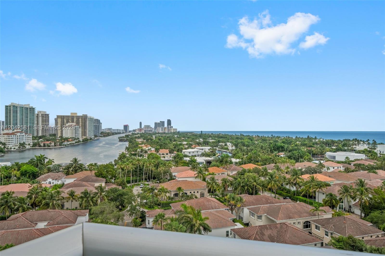 An elevated view shows a residential neighborhood with tiled roofs, palm trees, and a waterway — 19380 Collins Ave # 1224, Sunny Isles Beach FL 33160, SUNNY ISLES BEACH, FL