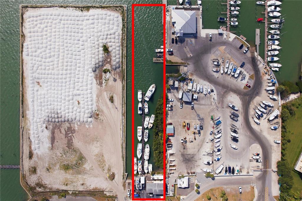 An aerial view shows a marina slip outlined in red between a land parcel and docks — 545 150TH AVENUE, MADEIRA BEACH, FL