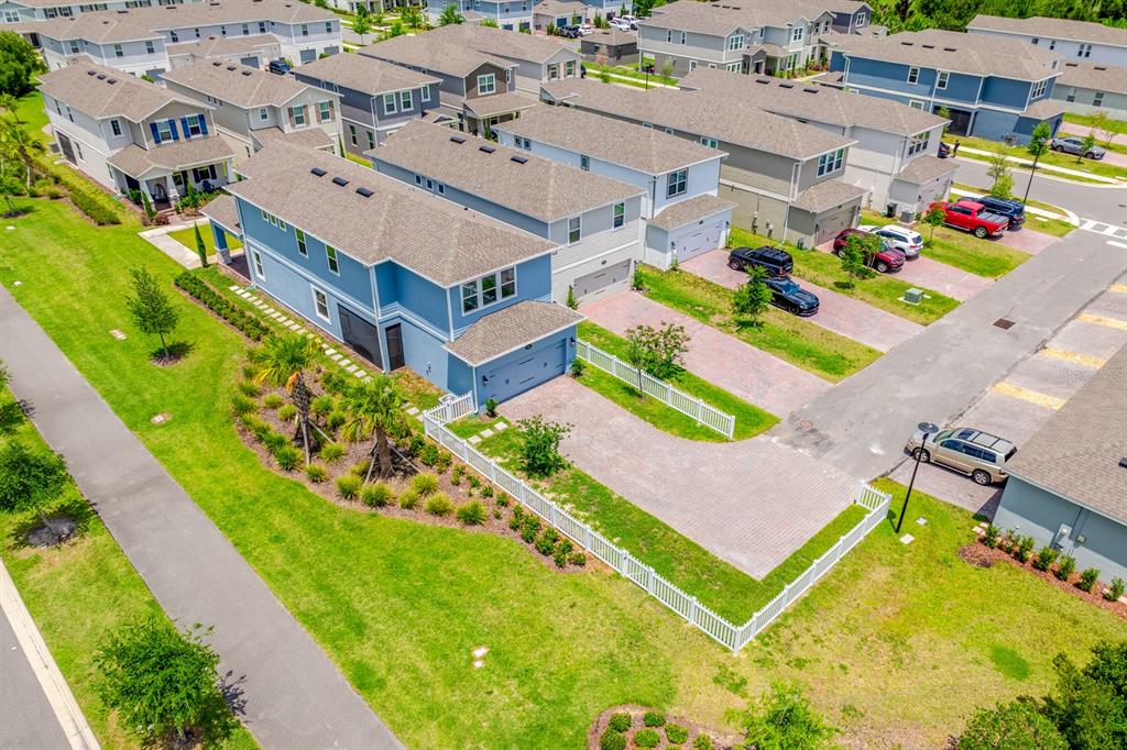 A two-story blue house with a stone-accented porch and a small front yard — 640 DOGFISH LANE, DEBARY, FL