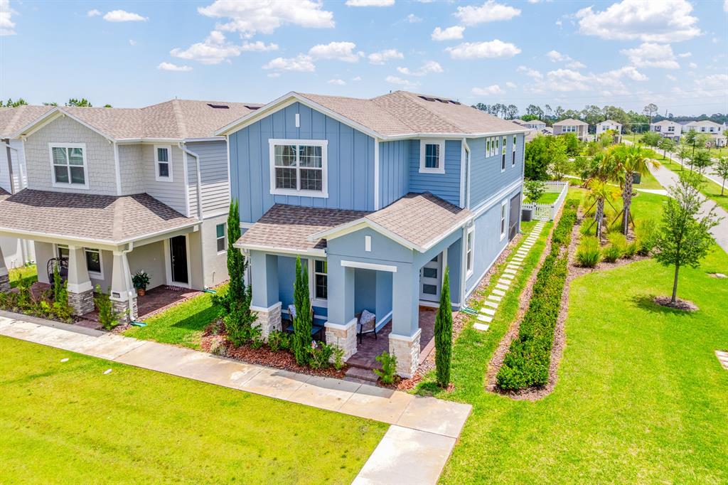 An aerial view shows a blue two-story house with a fenced yard and driveway — 640 DOGFISH LANE, DEBARY, FL