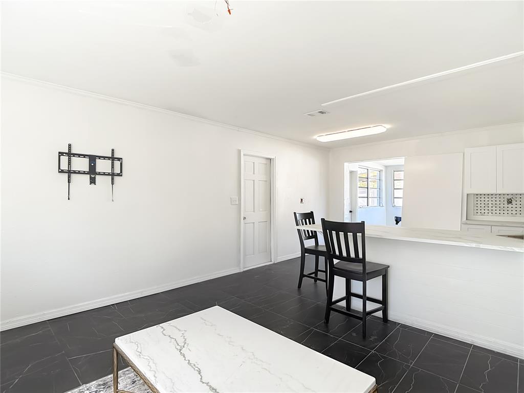 A living room features black tile flooring, a white marble coffee table, and bar seating — 6726 DEL PRADO TERRACE, NEW PORT RICHEY, FL