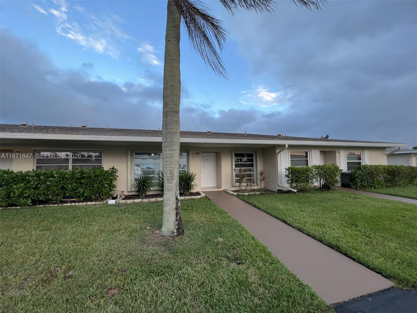 A single-story house with a palm tree in the front yard and a concrete walkway — 20927 Sedgewick Dr, Boca Raton FL 33433, BOCA RATON, FL