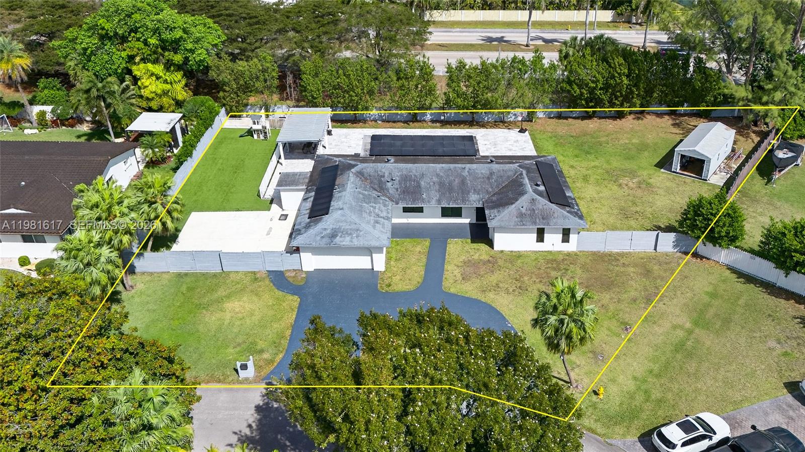 An aerial view shows a single-story house with a dark roof, driveway, and large yard — 11951 SW 120th Ter, Miami FL 33186, MIAMI, FL