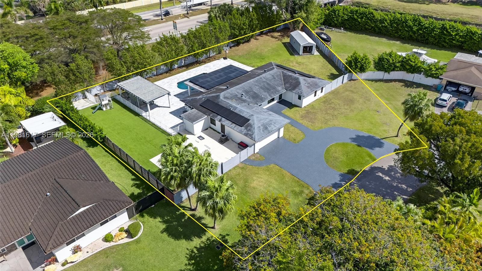 An aerial view shows a house with a pool, patio, and driveway within a fenced lot — 11951 SW 120th Ter, Miami FL 33186, MIAMI, FL