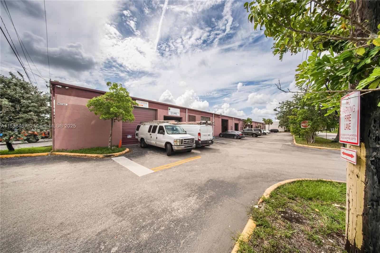 A row of commercial warehouse units with parked vans and a fire lane sign — 1375 NW 65TH AV, Plantation FL 33313, PLANTATION, FL
