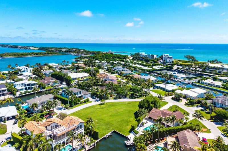 An aerial view shows a coastal residential neighborhood with houses, canals, and the ocean — 102 Bonito Drive, Ocean Ridge FL 33435, OCEAN RIDGE, FL