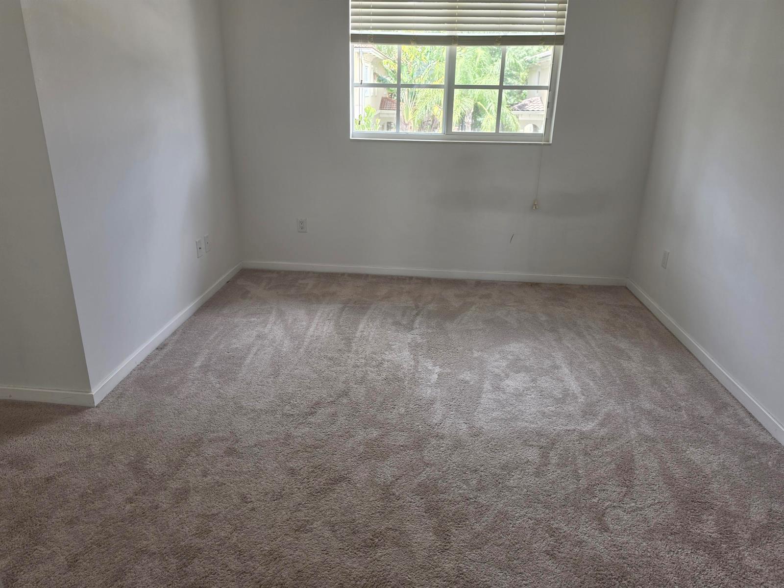 An empty bedroom with beige carpet, white walls, and a window with blinds — 2615 SW 81st Terrace # 2599, Miramar FL 33025, MIRAMAR, FL