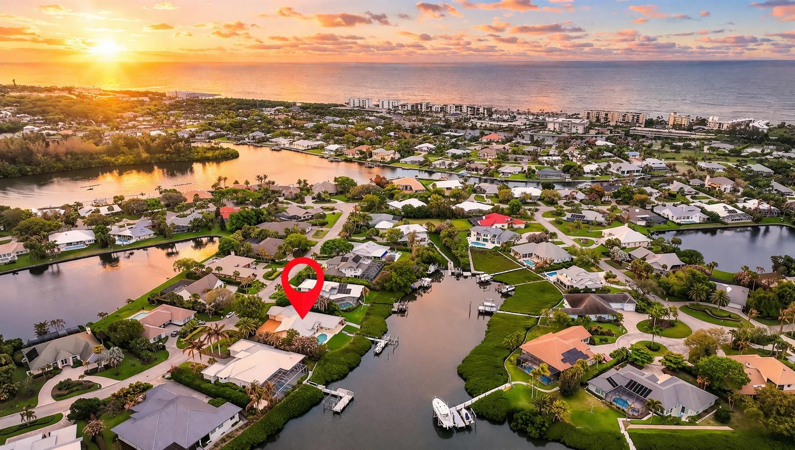 An aerial view shows a waterfront house with a pool marked by a red pin — 69 Cache Cay Drive, Vero Beach FL 32963, VERO BEACH, FL