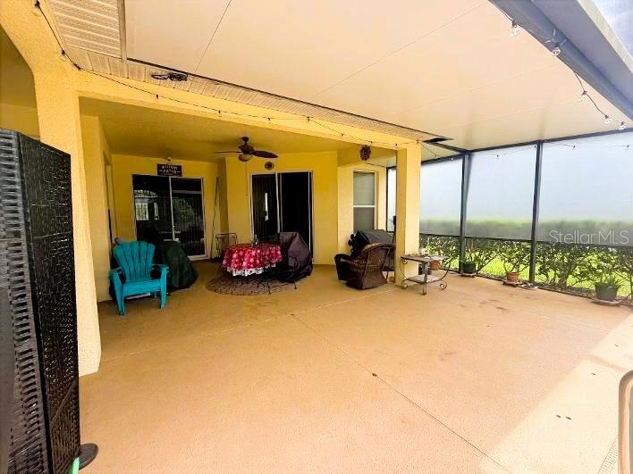 A kitchen with wood cabinets, granite countertops, stainless steel appliances, and wood-look tile flooring — 3814 THORNEWOOD WAY, CLERMONT, FL