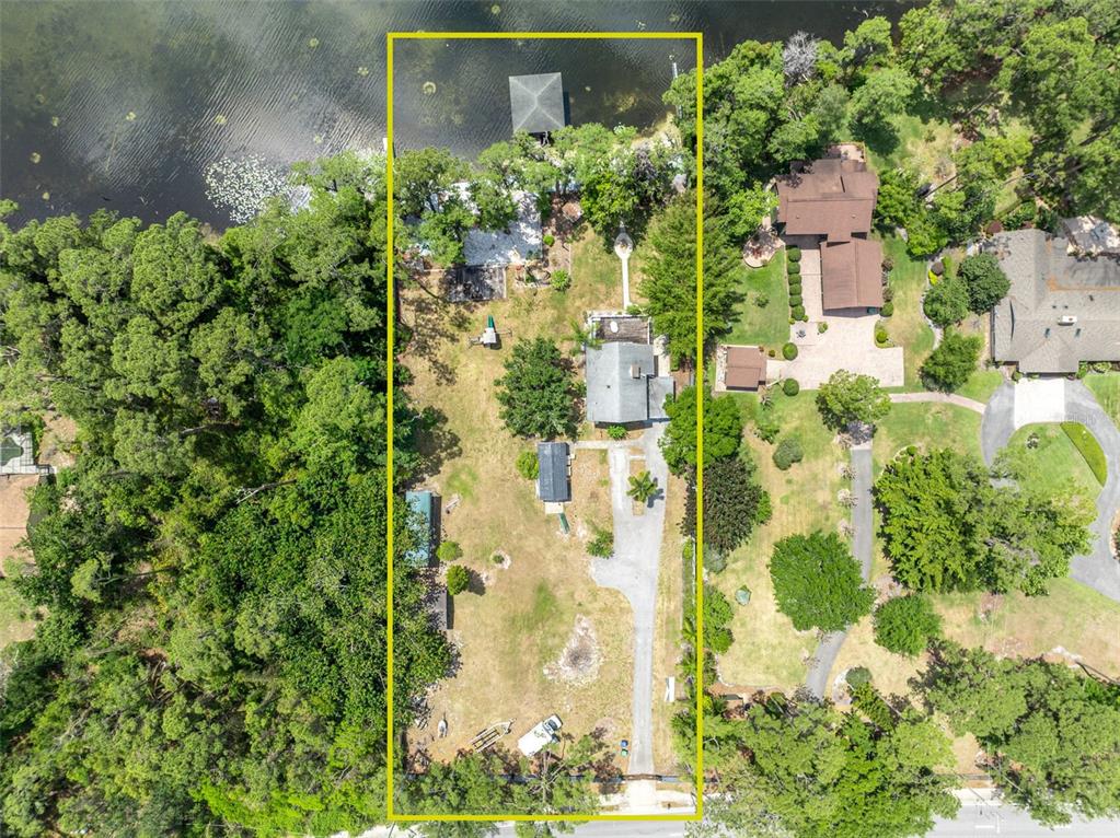 An aerial view shows a rectangular residential lot with a house, driveway, and lake access — 11424 WESTWOOD BOULEVARD, ORLANDO, FL