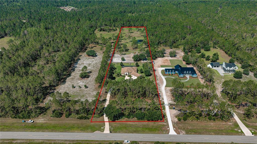 An aerial view shows a large residential property outlined in red, featuring a house and driveway — 4345 OLD KINGS ROAD N, PALM COAST, FL